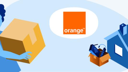 femme transportant un carton maison avec carton d'équipements fibre et logo orange